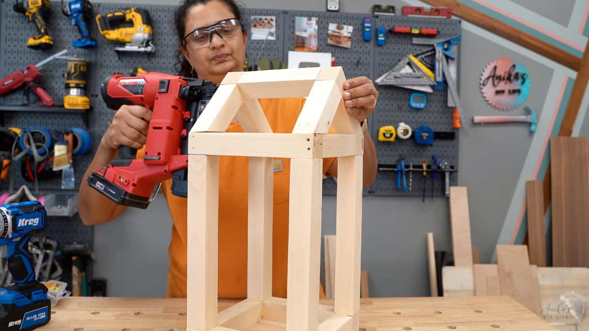 Adding the center beam on the house shaped lantern.