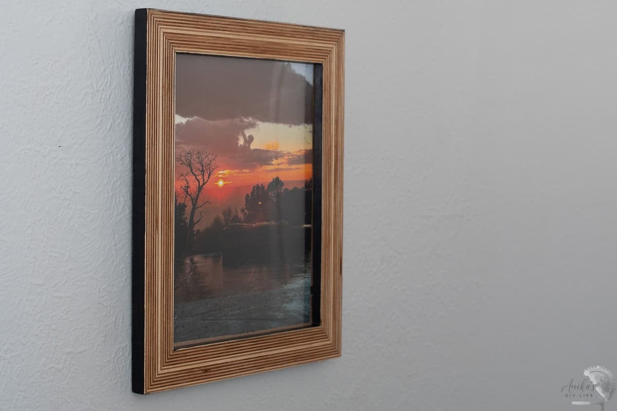 DIY plywood picture frame on the wall