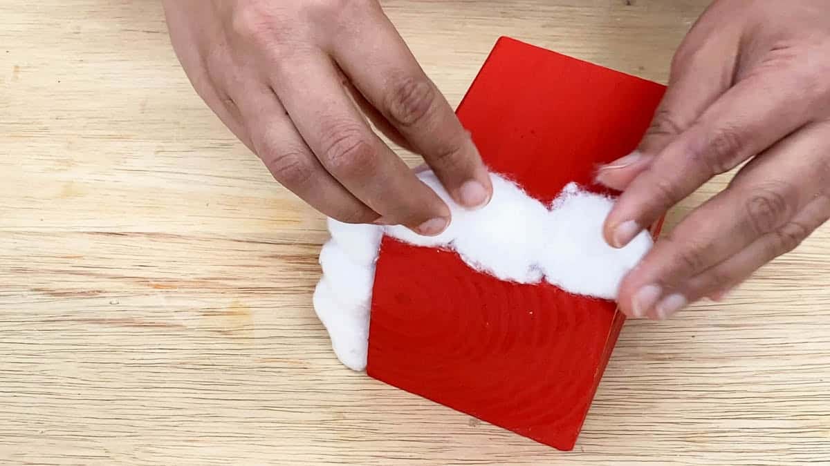 Finishing Santa's pants on the bottom block using cotton