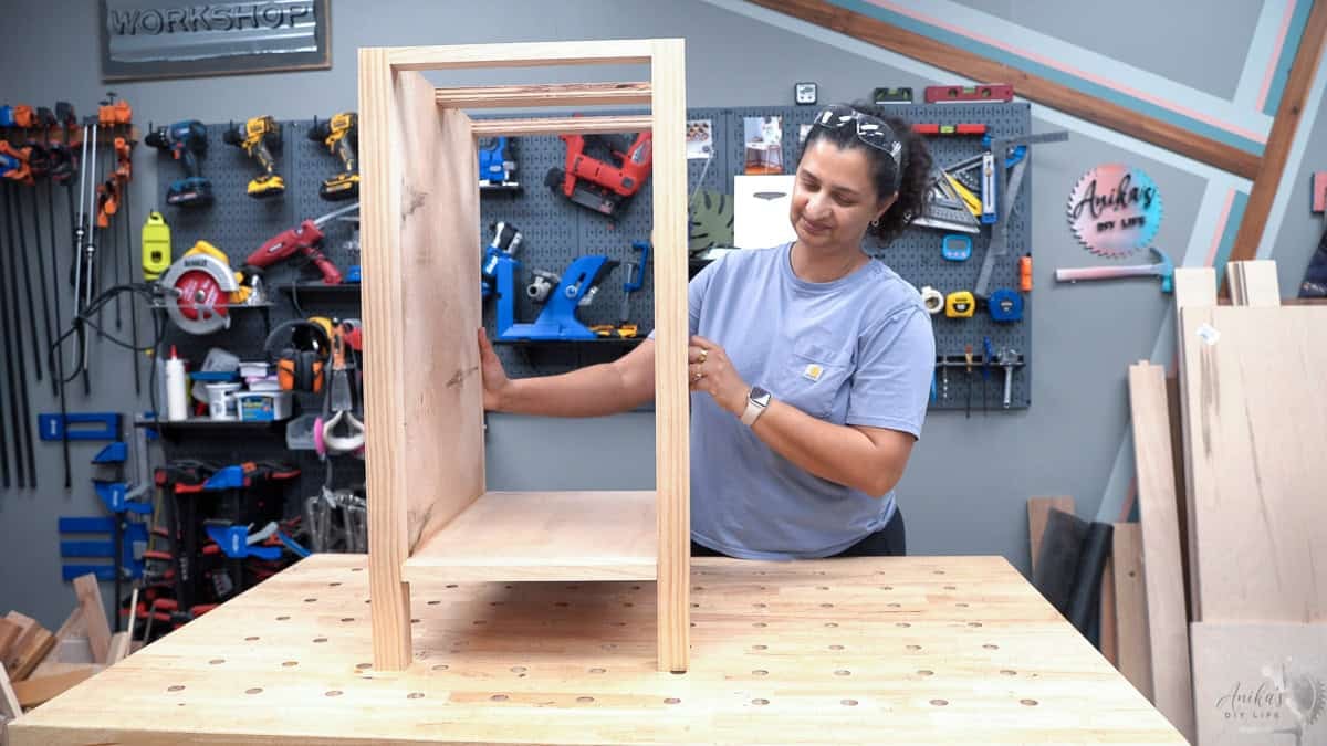 Anika with the completed shelf unit for the diy desk
