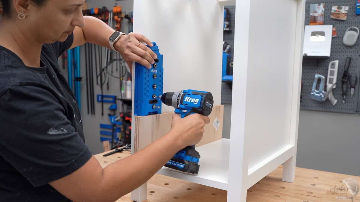 Making holes for the shelf pins using a shelf pin jig