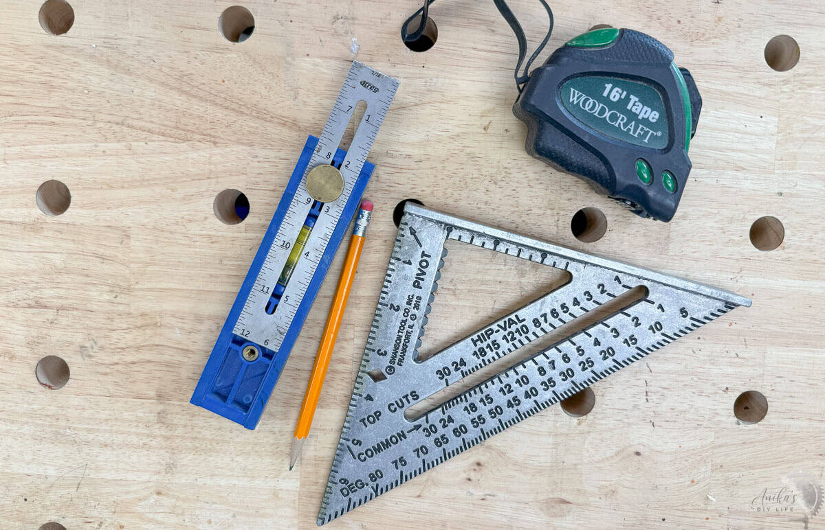 Essential measuring and marking tools for woodworking including a 16ft tape measure , a speed square , a sharp pencil , and the versatile Kreg Multi-Mark tool.