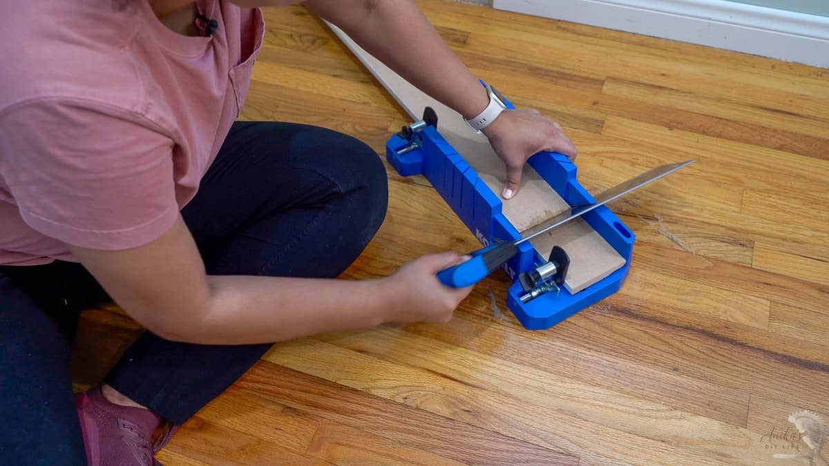 using a miter box to cut baseboards