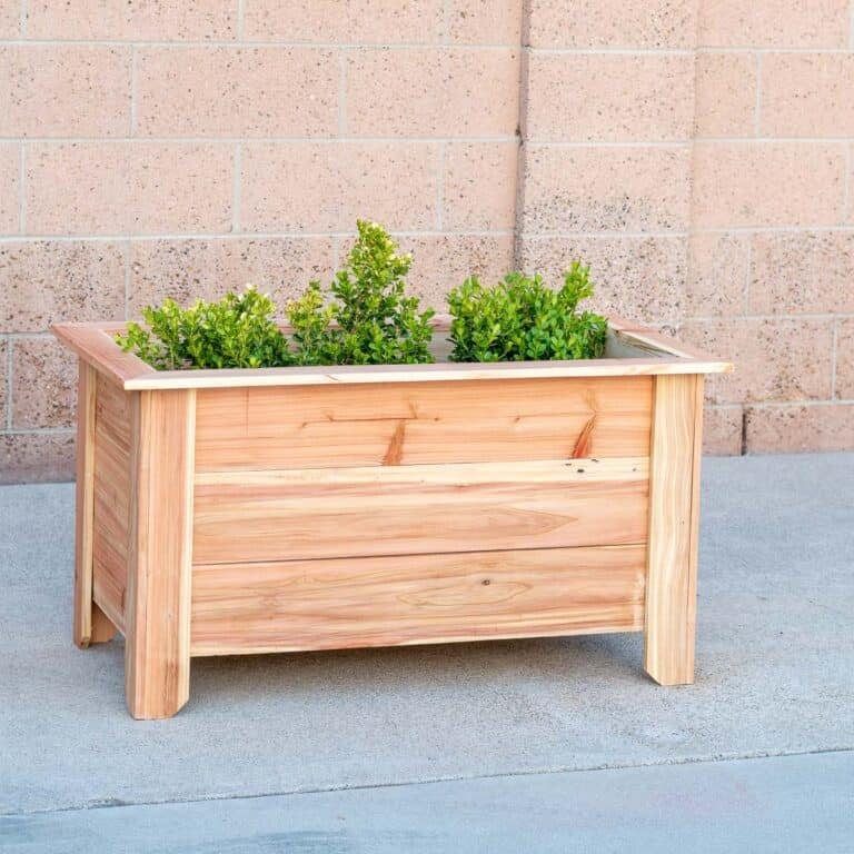 Learn how to build a DIY cedar raised planter for under $30 with these step-by-step tutorials and free plans. Perfect for herbs and vegetables.