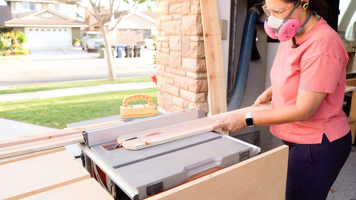 anika ripping cedar boards on the table saw.