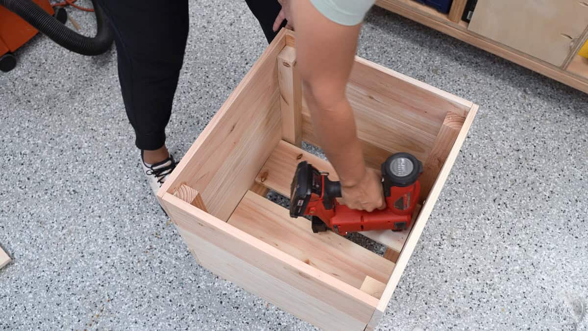 Attaching slats to the bottom for support of the plant pot and drainage.