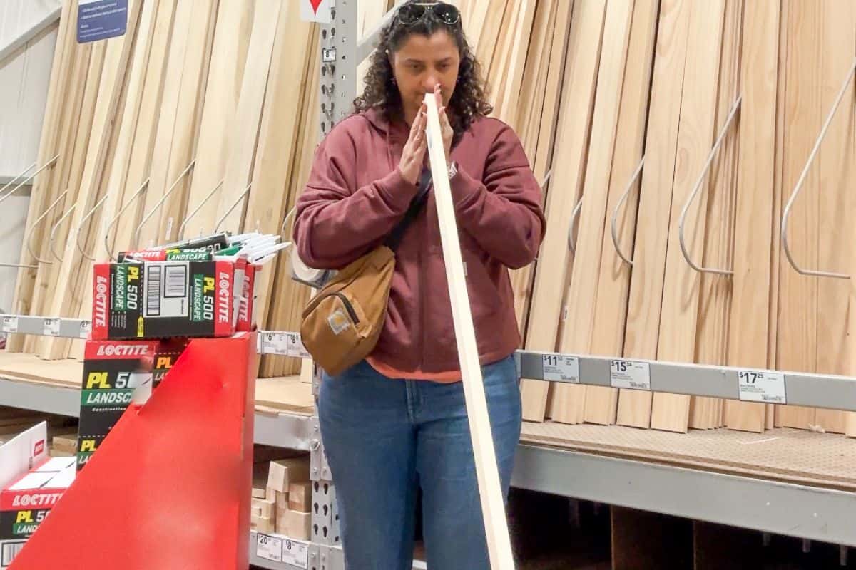 checking a board for straightness at the home improvement store