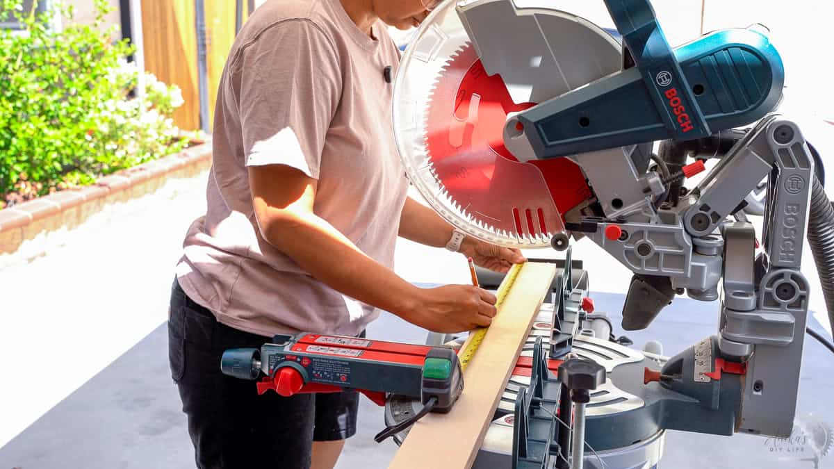Measuring and marking a board to cut on a miter saw