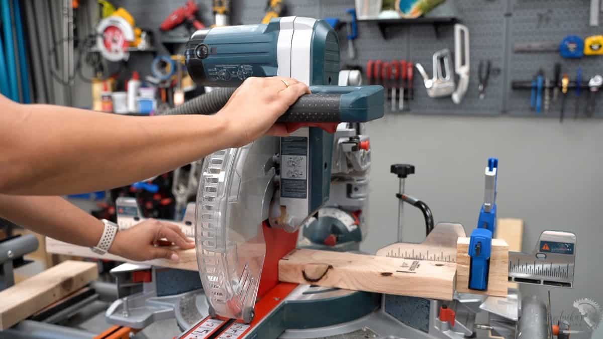 Anika showing how to use a stop block on a miter saw to make repeated accurate cuts