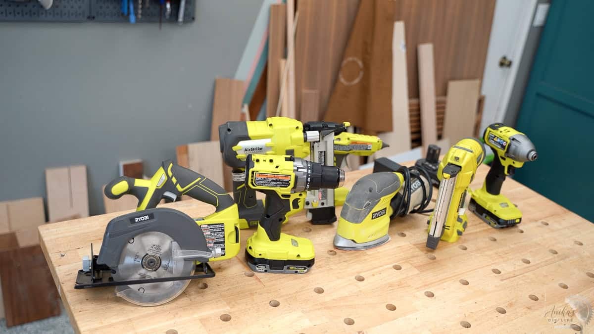 A collection of Ryobi tools on the workbench in a workshop